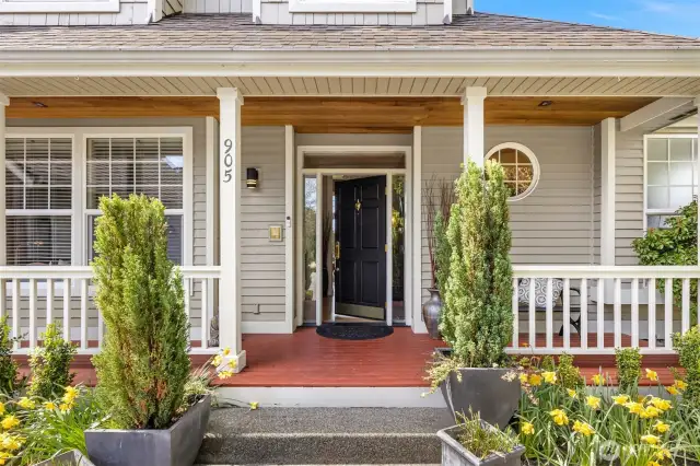 The inviting covered porch offers a warm welcome in every season, providing shelter from the elements while setting the tone for the home's timeless charm. Whether it’s a soft summer rain or a crisp autumn breeze, this gracious entryway embraces guests with comfort and elegance before they even step inside.