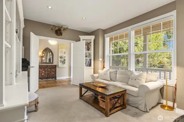 Just to the left of the front door, off the foyer, you'll find a welcoming den or office featuring a cozy wood stove—an ideal spot for watching movies, reading, or simply enjoying a bit of peace and quiet.