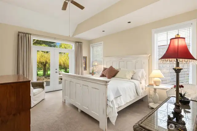 The primary bedroom is conveniently located on the main floor, just off the living room and den/office. French doors open to a private section of the backyard—an ideal spot to watch golfers pass by, enjoy a sunset cocktail, or savor your morning coffee.