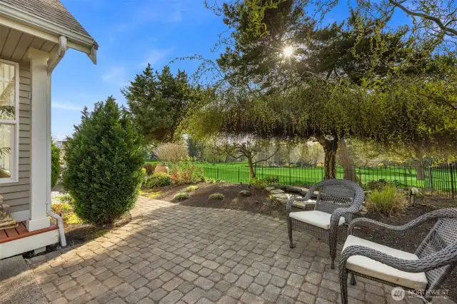 The west-facing sun filters gently through the beautiful trees, adding a serene, dappled light that enhances the enjoyment of the yard.