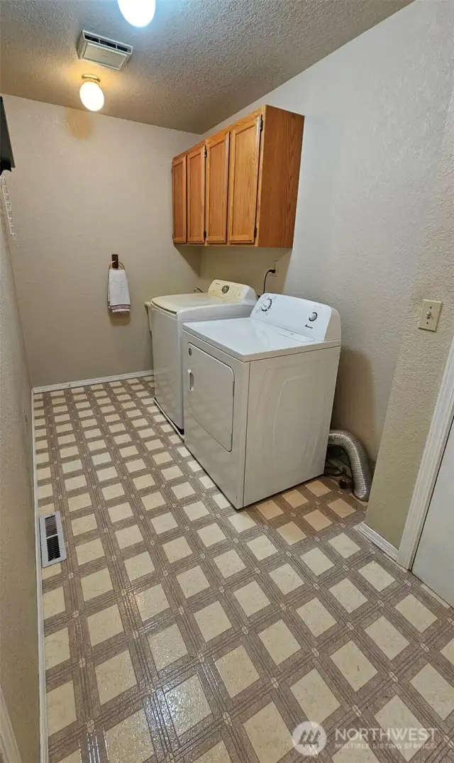 Large laundry room with storage cabinet and sink basin