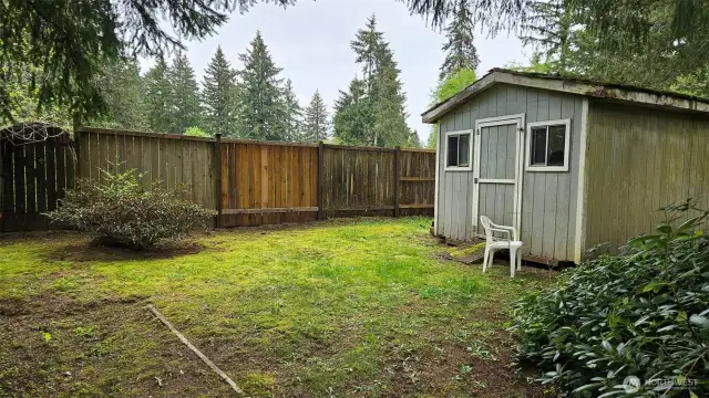 Older shed and doghouse at the back of the property—a great place to store yard tools. Fence backs up to a greenbelt.