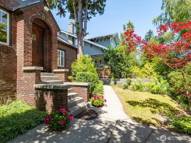 Entry to 1853 23rd Ave E. This stately brick Tudor is just minutes from top-rated schools, parks, UW, light rail & the Arboretum.