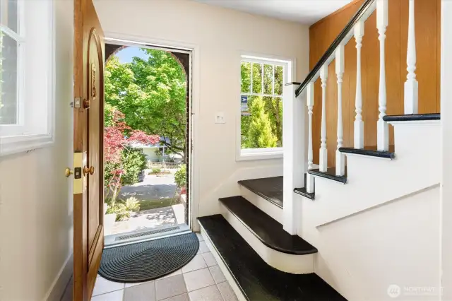Entry with grand staircase to upper level.