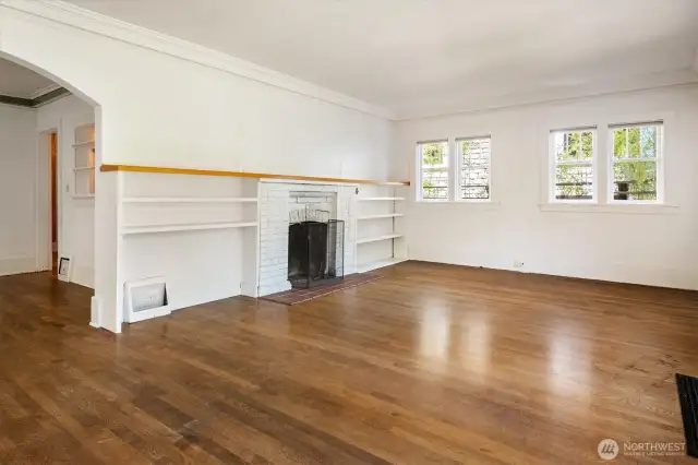 Original wood floors and fireplace in the living room.