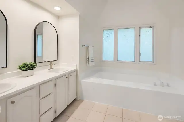 Five piece primary bath features new sinks, hardware, and mirrors.