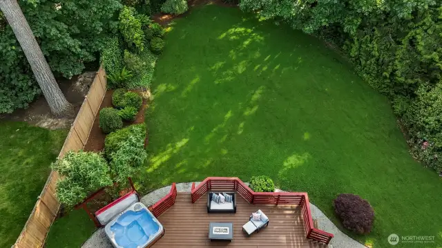 Sliders in kitchen open up to a level shy acre yard which is remarkably large for the neighborhood.
