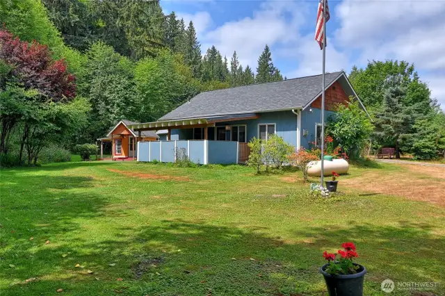 Looking at the back of the home covered deck of kitchen
