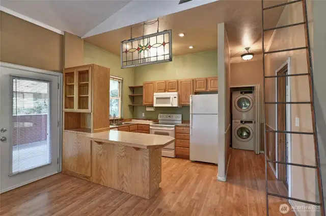 Kitchen looking down hallway to laundry closet