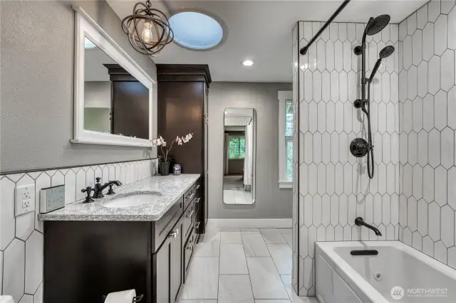 Fully updated primary bath with radiant floor heating and attached walk-in closet