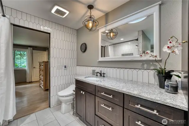 Fully updated primary bath with radiant floor heating and attached walk-in closet