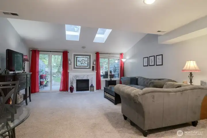 Light and bright with newer carpet and paint. Redone fireplace with tile surround and wood mantle