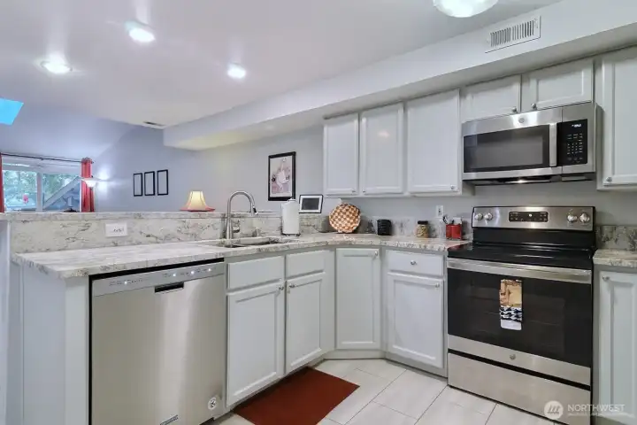 Light Grey cabinets, stainless alliances and gorgeous quartz counters
