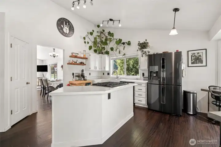 The kitchen has a pantry and opens to the dining room in the background