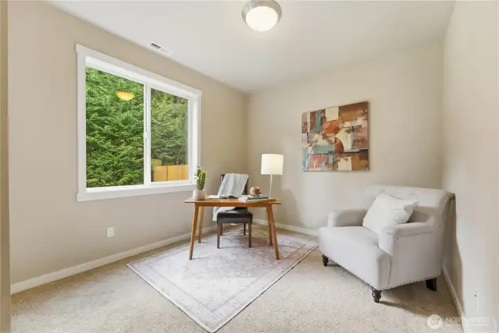 This downstairs bedroom offers excellent flexibility—ideal as an office, guest room, or multi-generational space with a 3/4 bathroom conveniently located right next door