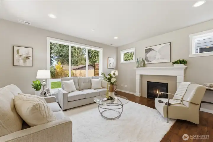 The living room features tall ceilings, a gorgeous gas fireplace, and abundant natural light while maintaining exceptional privacy