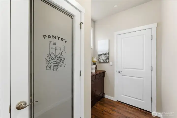Close-up of the walk-in pantry and the door to the garage, highlighting this highly practical and efficient kitchen layout