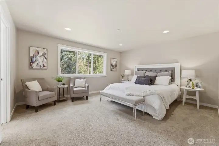 At the far end of the hallway, the privately located primary bedroom offers a spacious retreat with calming colors, an ensuite bathroom, and abundant natural light.  Staged with a King size bed