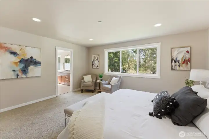Additional view of the spacious primary bedroom, with a glimpse of the adjoining ensuite bathroom