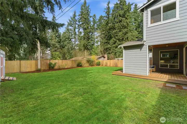 A side perspective of the covered patio, with a gentle peek at the spacious garden shed just off to the left