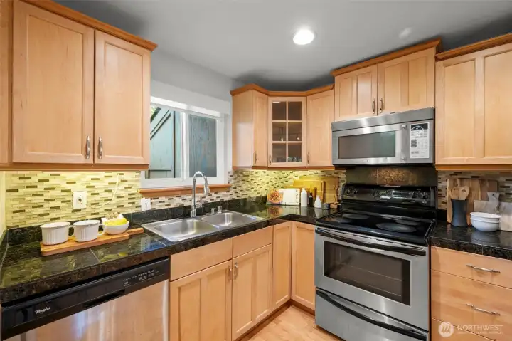 Beautifully updated kitchen with granite counters and stainless appliances - all stay!