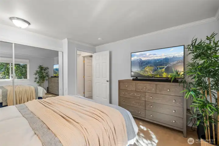 Primary bedroom with mirrored closet doors