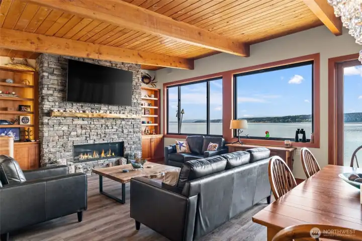 Great room with custom fireplace and floor to ceiling windows to allow the views in.