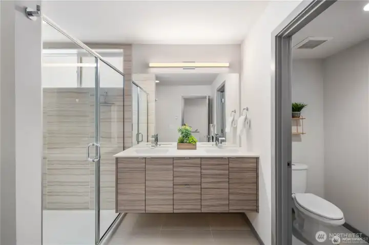 MASSIVE primary bathroom suite with walk-in shower, double vanity, storage closet and separate toilet area