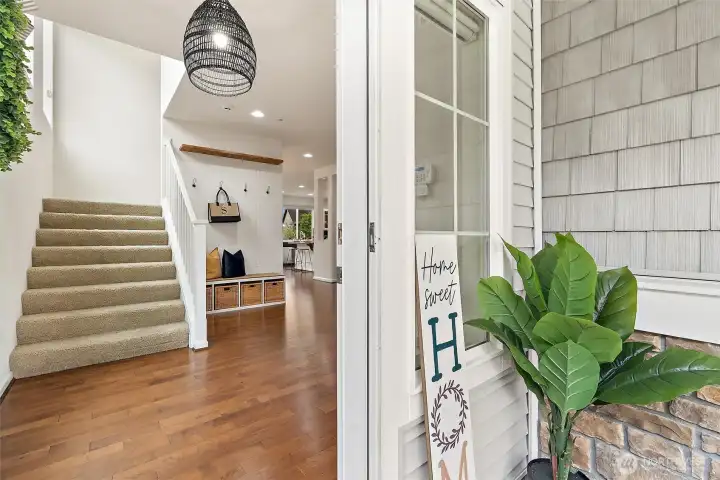 A warm and inviting entry welcomes you home with soaring natural light and rich hardwood floors.