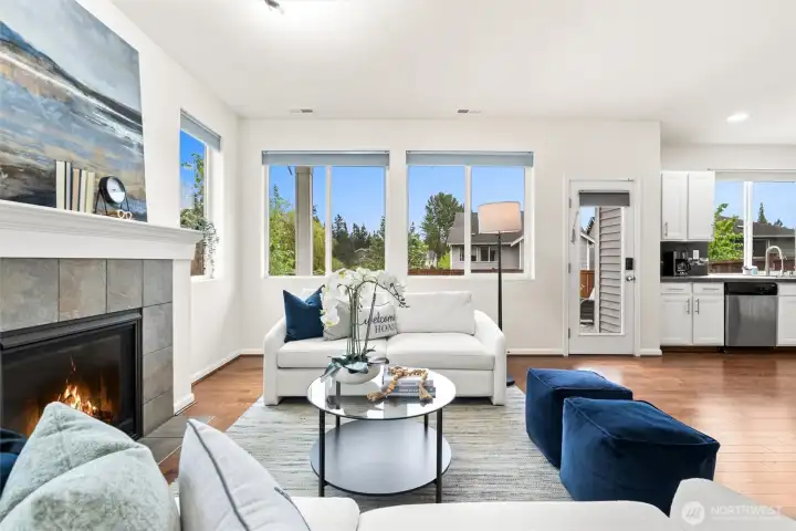 Bright and light living room featuring a cozy gas fireplace.