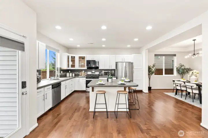 Modern and inviting kitchen featuring direct access to formal dining and outdoor entertainment space- creating the perfect blend of style, function and indoor/outdoor living.