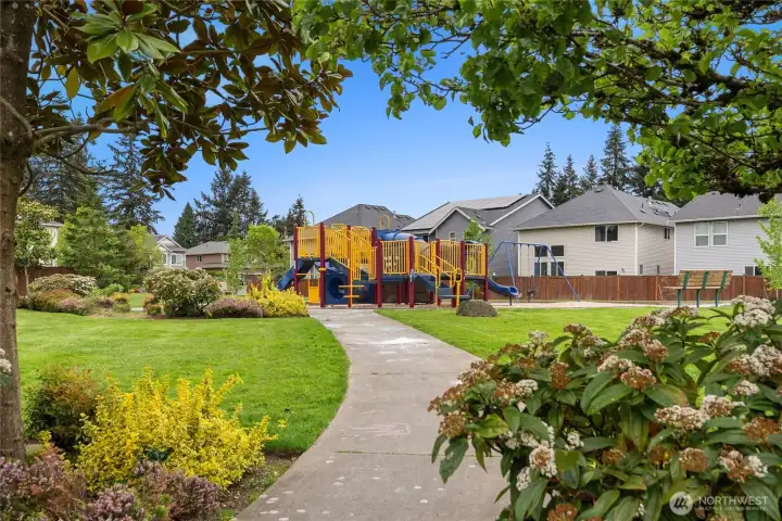 Private playground with lots of running around room across from the home.