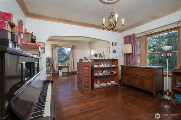 The formal dining room is located between the living room and the kitchen. Large windows allow for ample natural light.