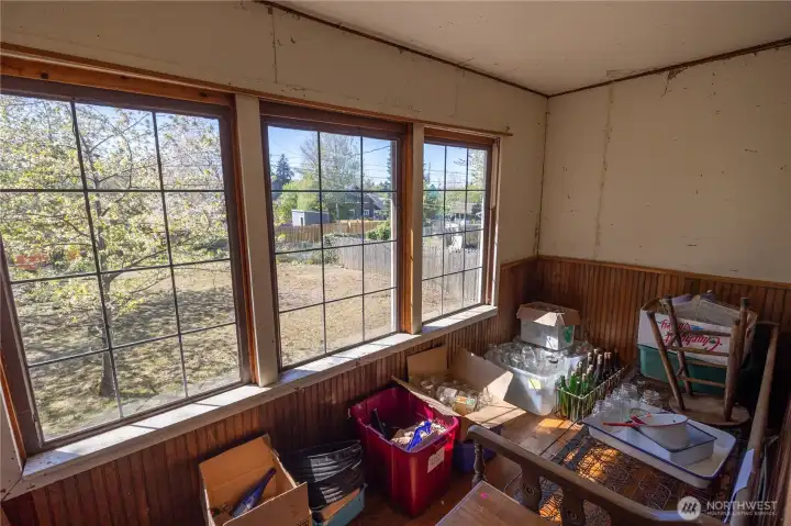 The back porch is framed in and would make an awesome sun room/green house or just a fun mudroom.