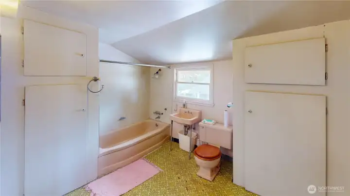 Big with pink fixtures- that's full bathroom number two located upstairs.