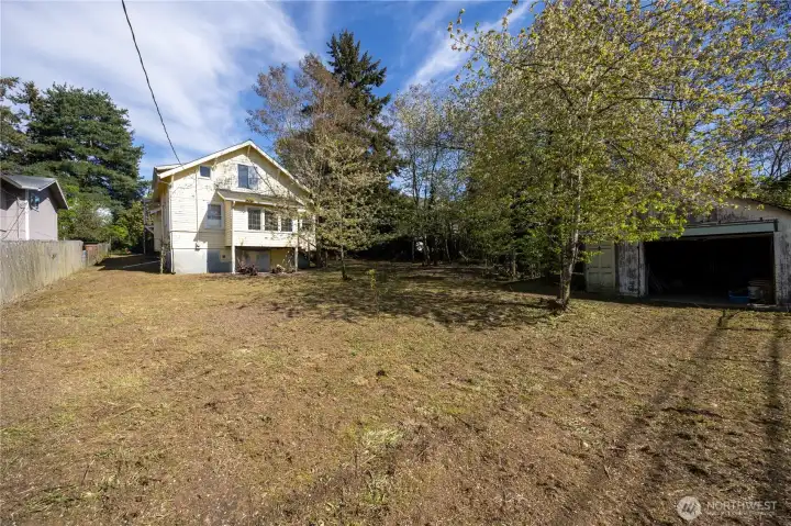 A large garage is located in the back of the yard.
