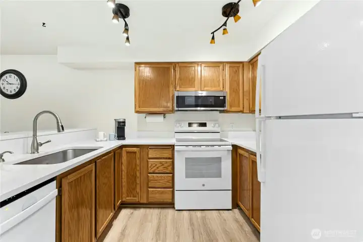 Another look at the kitchen with overhead lighting and ample counter space.