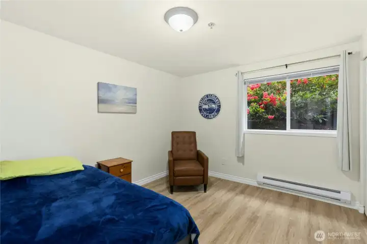 Bedroom 2 has a lovely view of flowering shrubs.