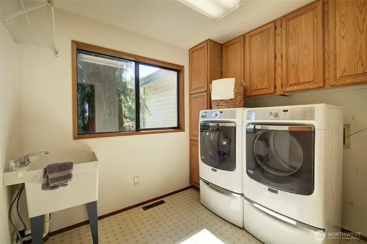 Main floor laundry room with built-in ironing board.