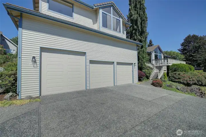 Large garage with additional flat parking area.