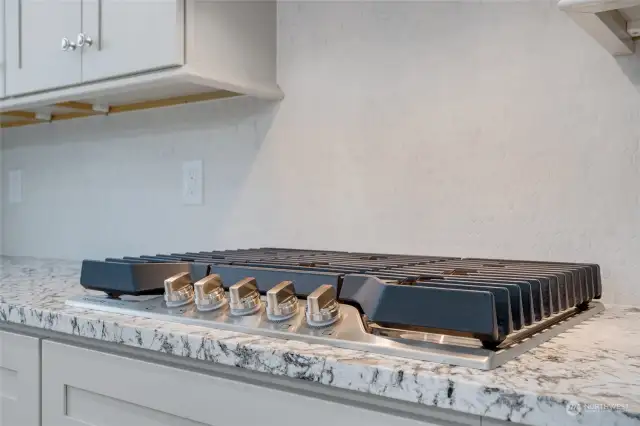 Full height custom tile backsplash and soft close cabinets & drawers.