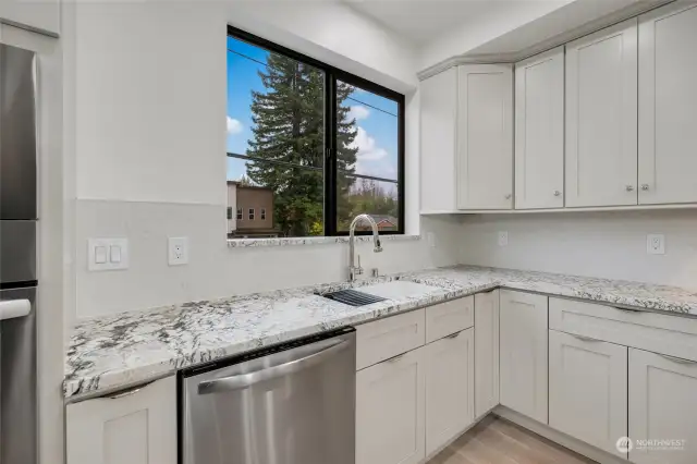 Gorgeous custom cabinetry, full-height backsplash and 3cm countertops.