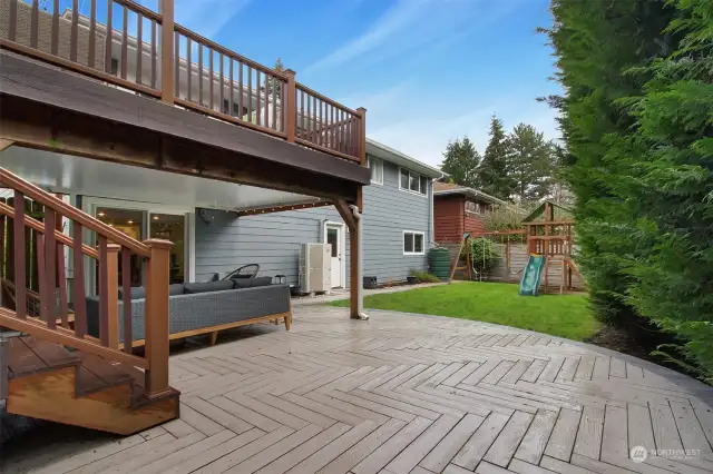 Private backyard with play area, lawn and patio.