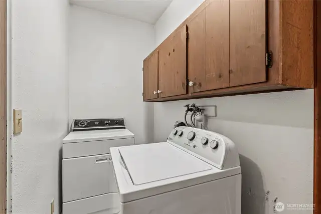 Laundry is thoughtfully tucked in at the primary end of the home.