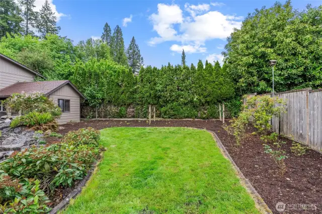 Concrete curbing surrounds the pretty yard tucked behind pond. Great privacy in this beautiful backyard!