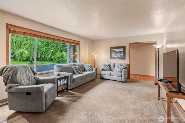 Neutral and bright living room just off front entry.