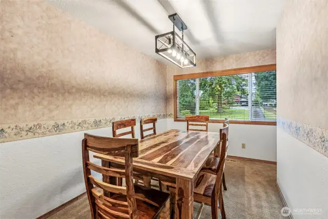 Formal dining room thoughtfully placed off kitchen in close proximity to living room. New fixtures and large window for natural light.
