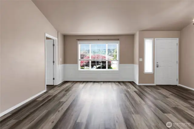 View of front door from kitchen area. To the left is an office (or bedroom?) with gas fireplace