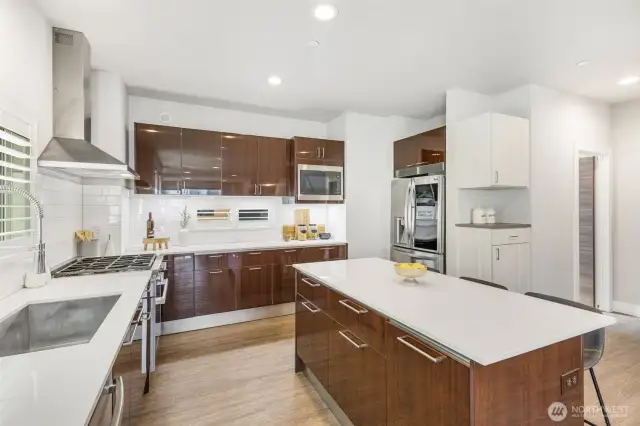 Kitchen features Ichijo’s signature piano finish cabinets with modular adjustable drawer dividers and hydraulic pull down shelf that makes reaching essentials a breeze
