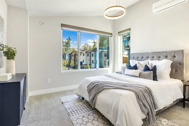 Primary bedroom features high ceilings and ample space to accommodate a king-size bed